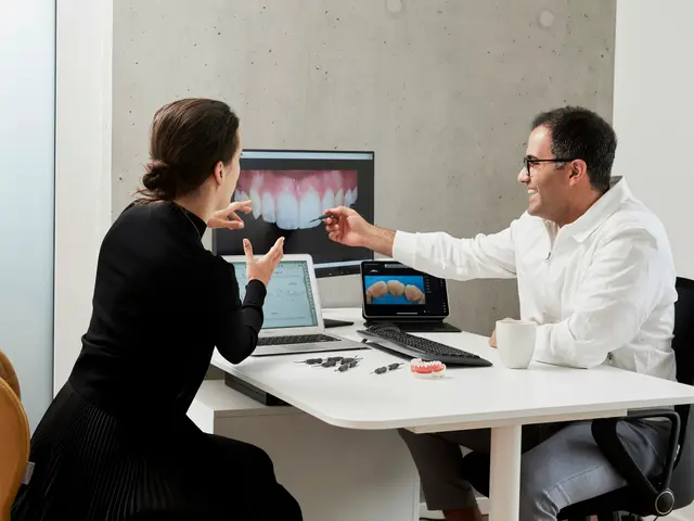 Dentist reviewing a smile image on a monitor with a patient