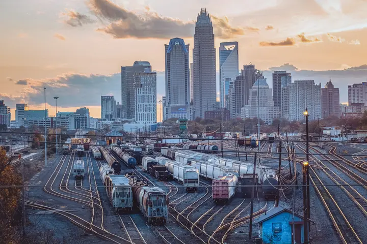 Uptown Charlotte skyline at sunset seen across the rail yard