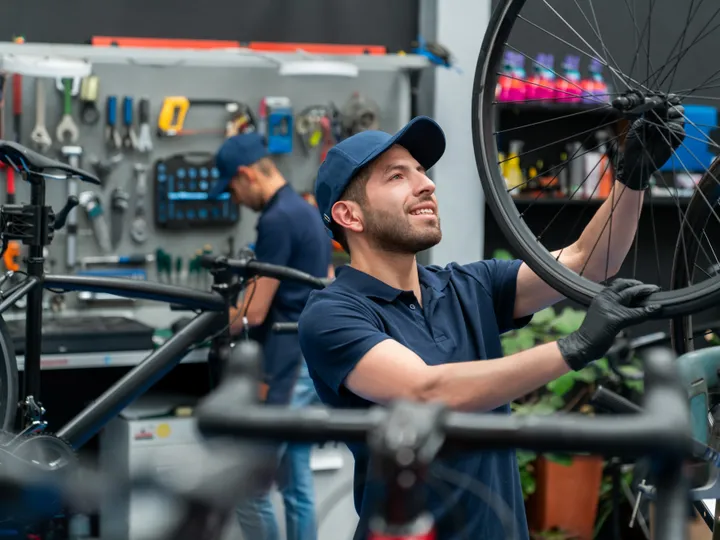 Bike shop owner at work in his repair shop, the kind of local business Google Ads brings customers to