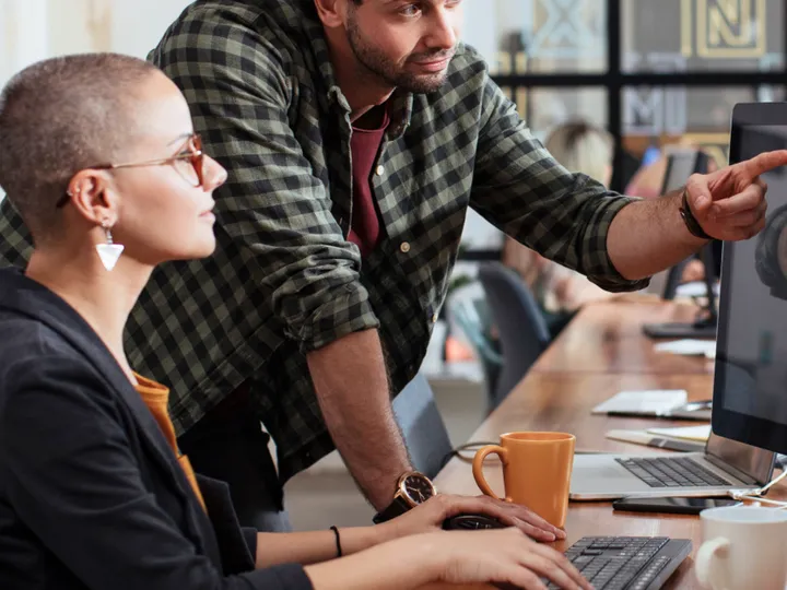 Two team members at a monitor working through a Google Ads account issue