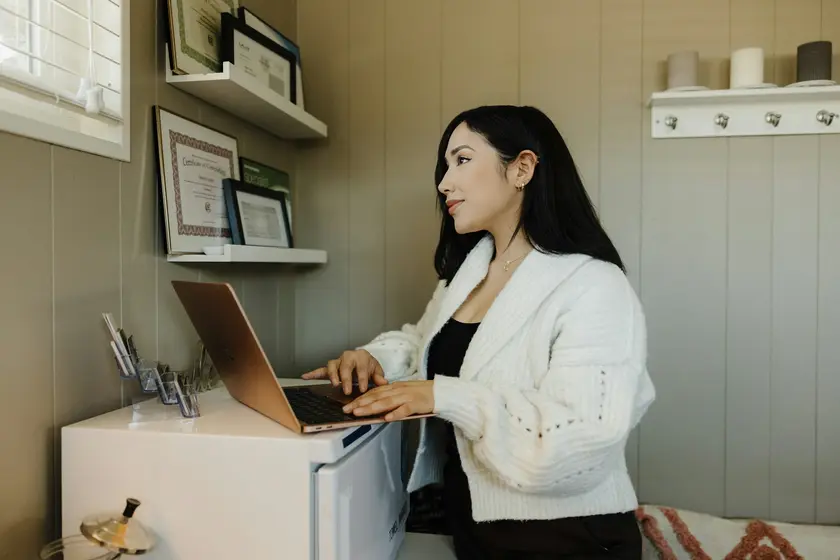 Small business owner working at a laptop in her studio office
