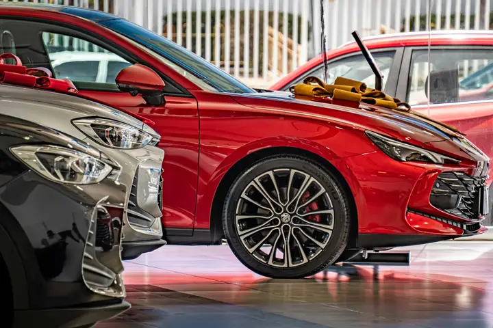 New cars lined up in a bright dealership showroom