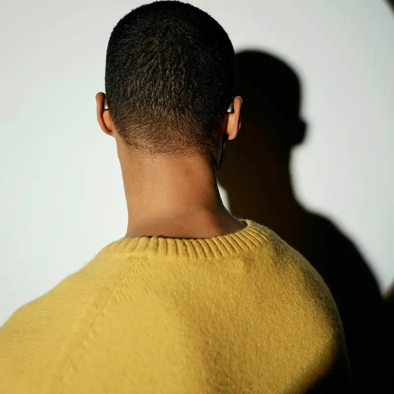 Email header photo: back of a man’s head with a fresh, even short haircut and a clean neckline, wearing a mustard sweater