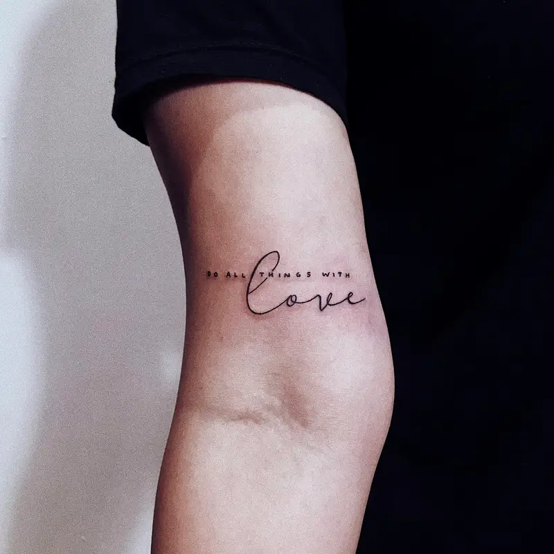 Email header photo: a healed fine line script tattoo on the inside of a person’s arm