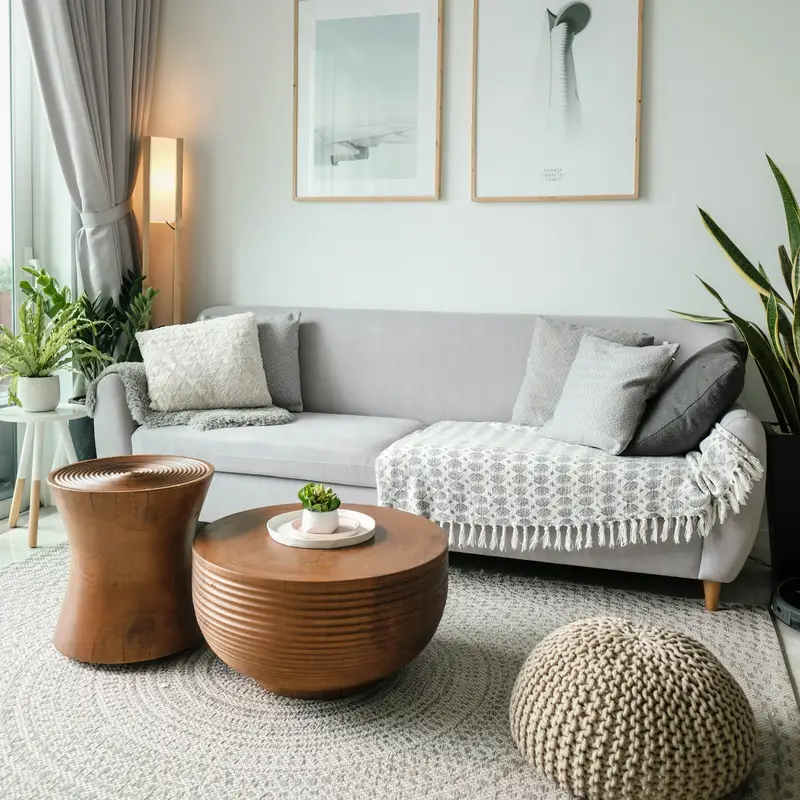 Email header photo: a light living room with a pale gray sofa, a woven rug, a round wooden coffee table and a knitted pouf