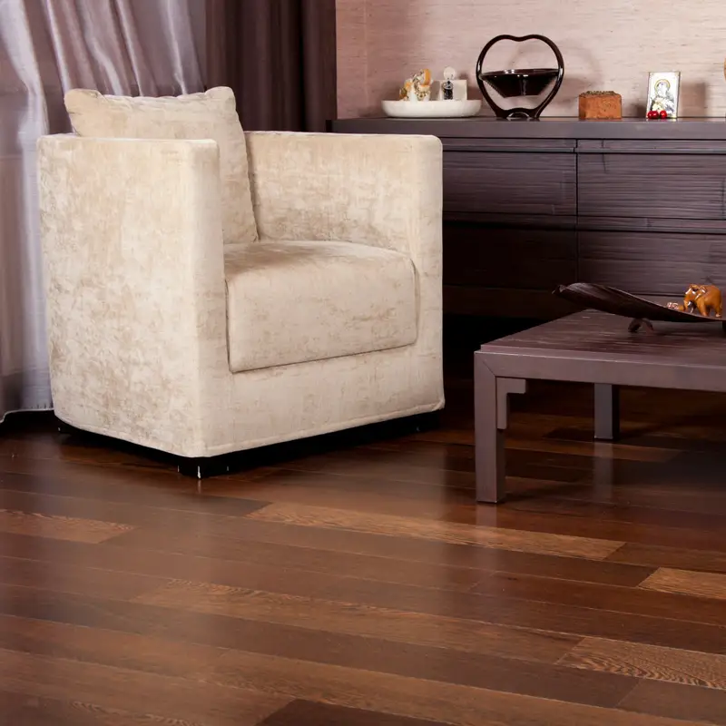 Email header photo: a sitting room with dark wide-plank hardwood floors under a cream armchair, a low wooden coffee table and a sideboard