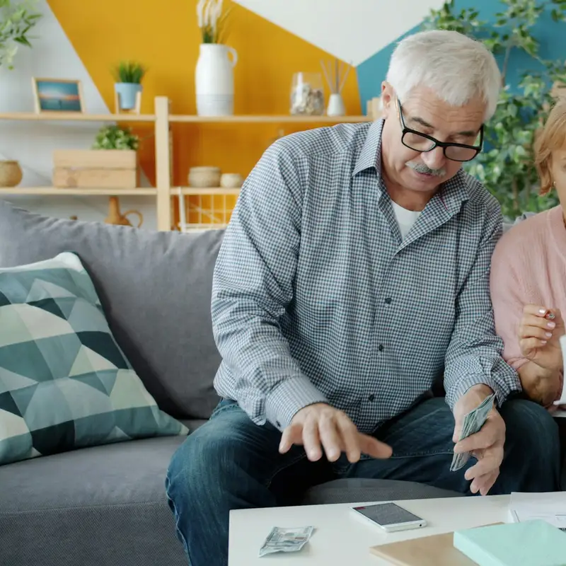 Email header photo: older couple reviewing documents together at home