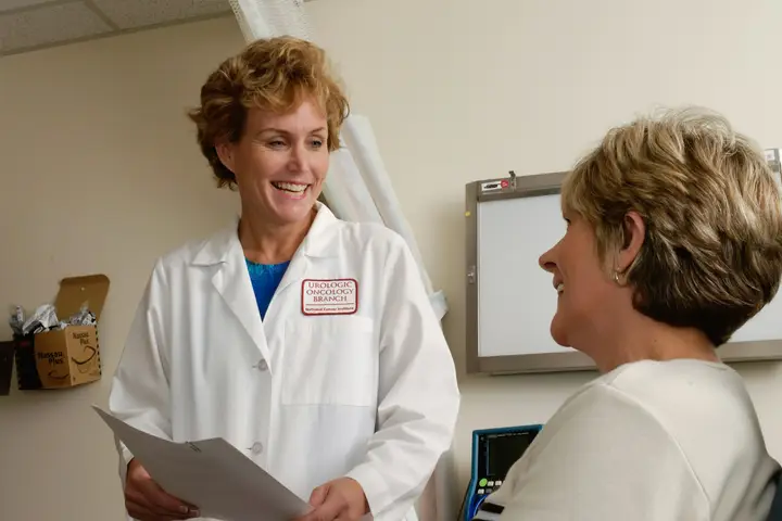 Doctor in a white coat talking with a patient in a clinic