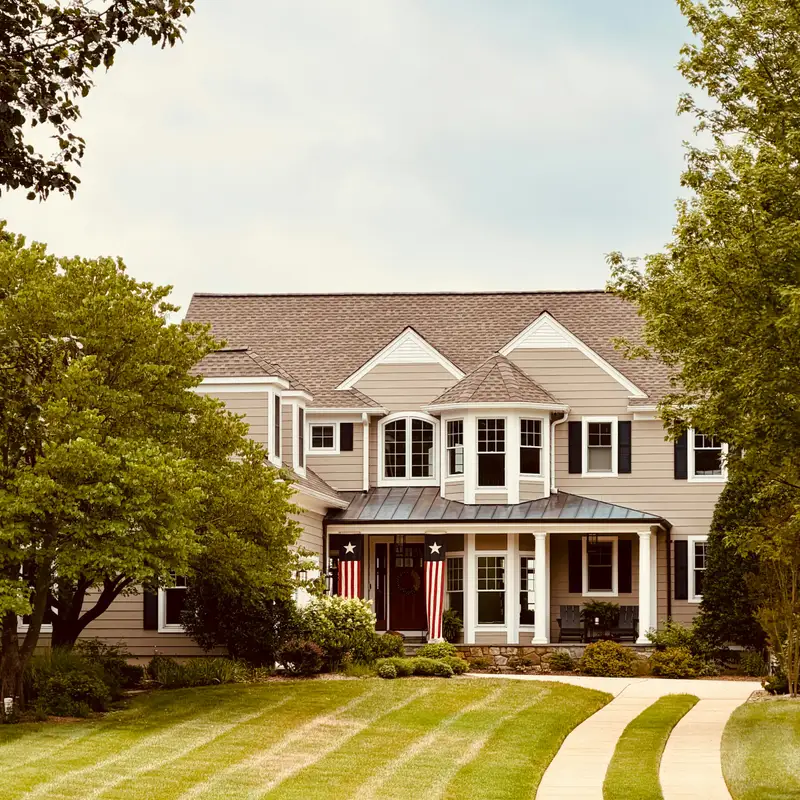 Email header photo: a freshly striped green front lawn beside a curving driveway leading to a large two-story house