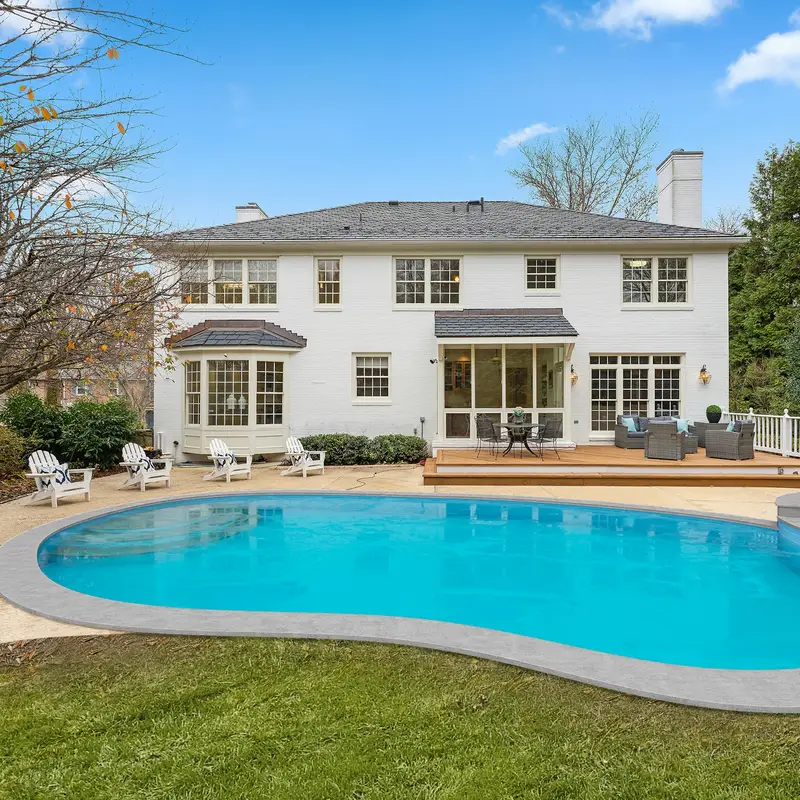 Email header photo: a clear blue backyard pool and spa behind a white two-story house with a deck and lounge chairs