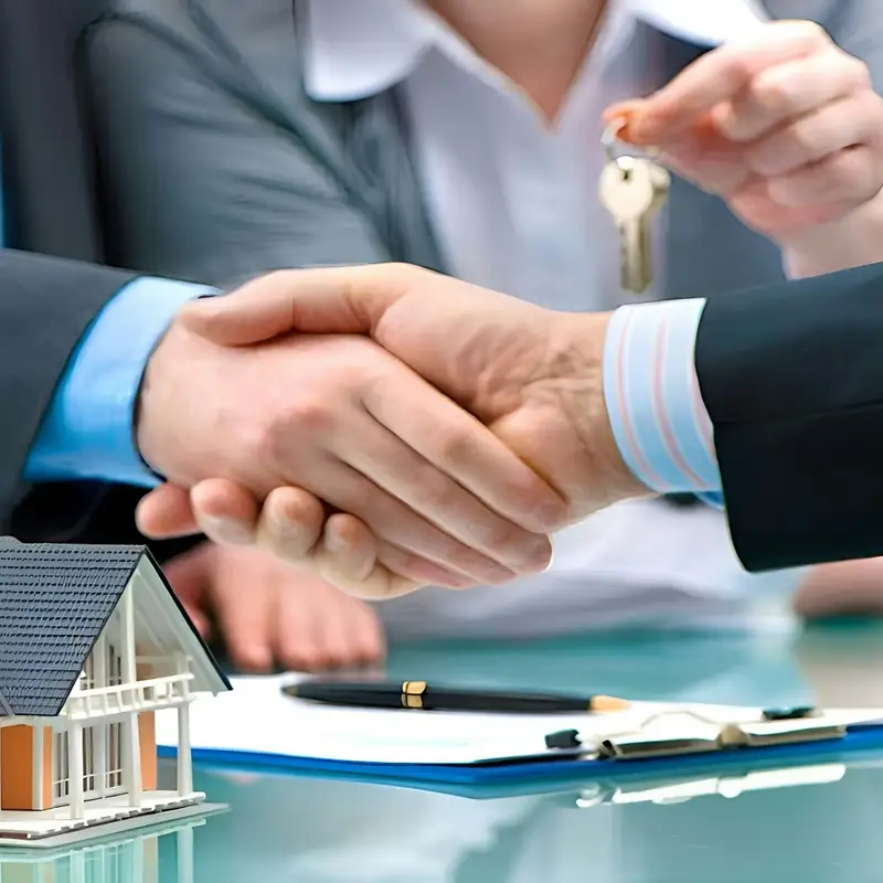 Email header photo: two men shaking hands over a small model house and a set of keys on a table