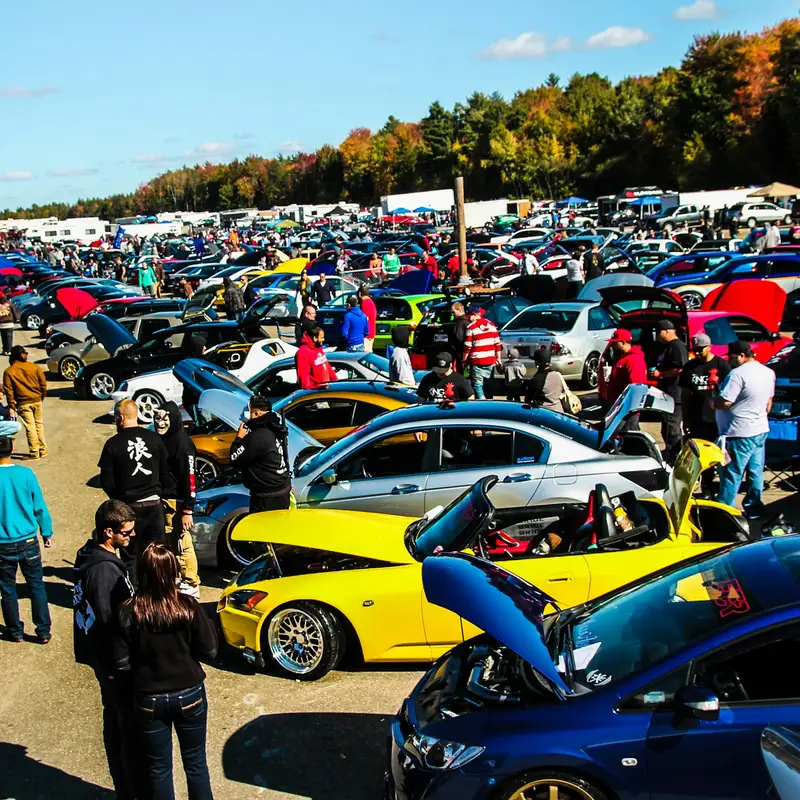 Email header photo: rows of modified cars with their hoods open at an autumn car show, with owners and visitors walking between them