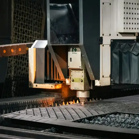 Industrial laser cutter cutting a part from a steel sheet