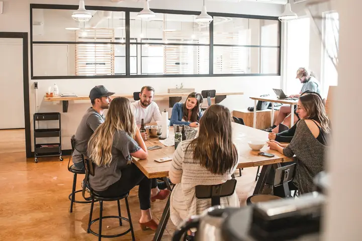 Business team talking around a conference table in a bright office