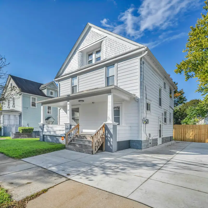 Email header photo: a white two-story house with a front porch, a new concrete driveway and a lawn on a sunny street