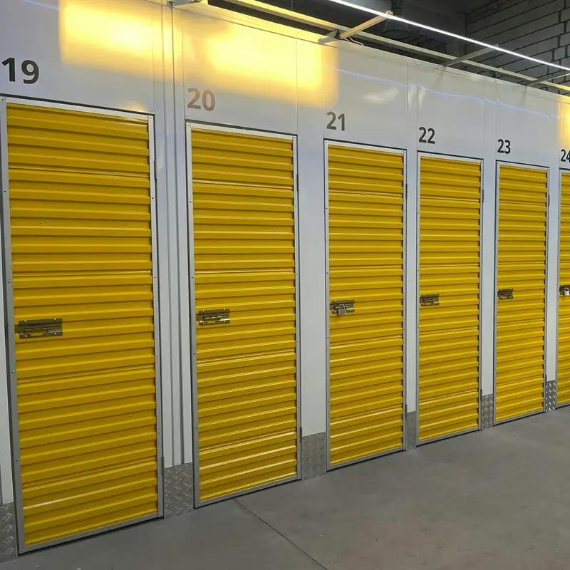 Email header photo: a bright indoor storage hallway lined with numbered units behind yellow roll-up doors