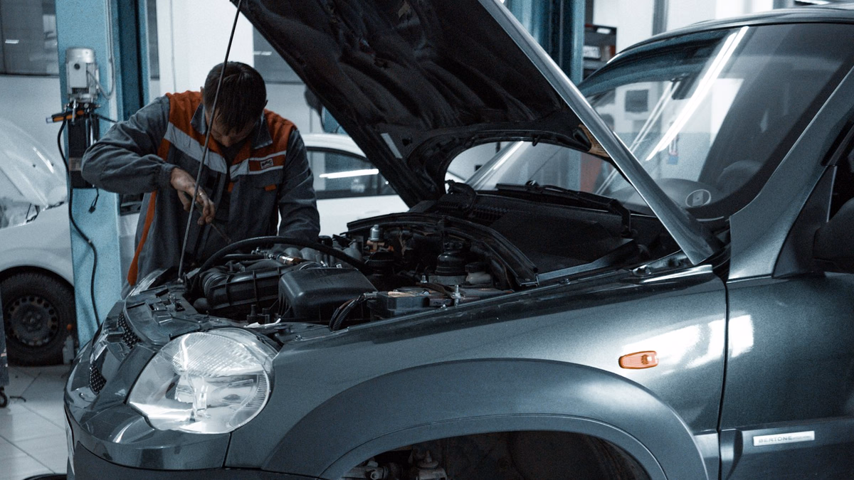 Automotive diagnostic specialist utilizing computerized scanner and oscilloscope on modern vehicle powertrain