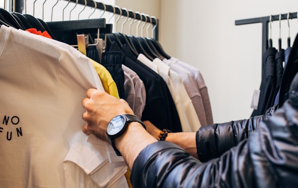 Customer shopping with a mobile device inside a boutique retail storefront