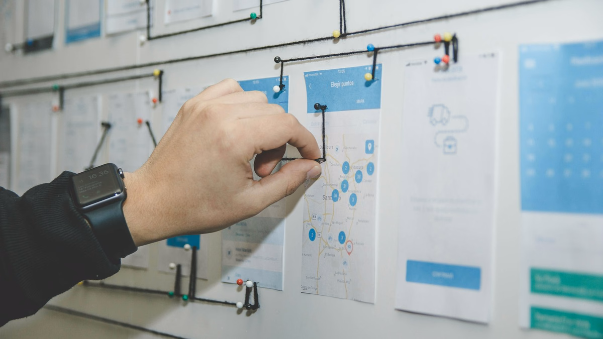 Technical SEO architecture team analyzing internal link equity flow and hub and spoke topic clusters on a glass whiteboard