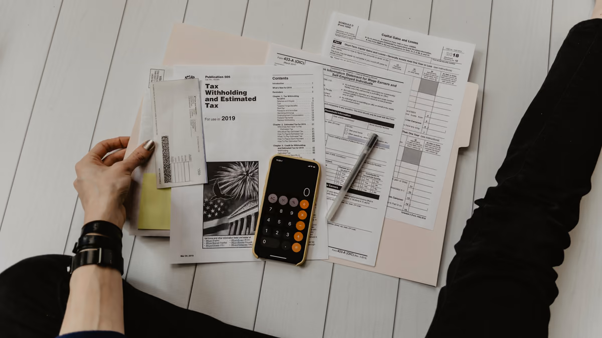 Strategist auditing Google Ads channel budget allocation and conversion performance with a calculator and laptop