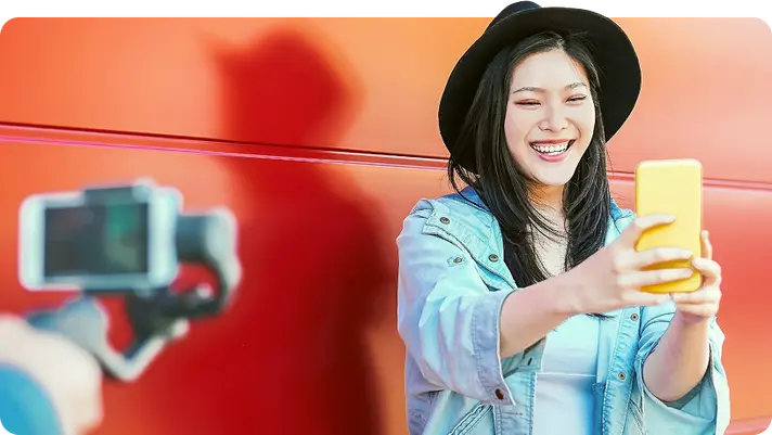 Creator filming herself with a phone on a gimbal for an Instagram video