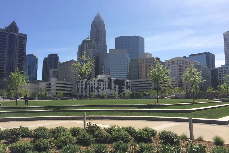 Romare Bearden Park green lawn and fountain with the Uptown Charlotte skyline in the background