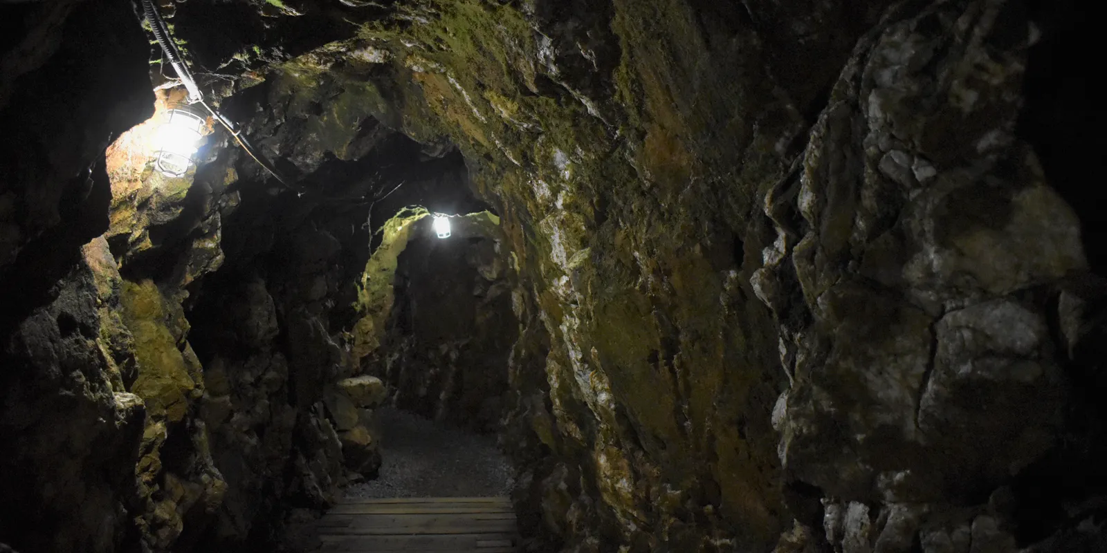 Historic underground mining tunnels illuminated during heritage tours at Reed Gold Mine