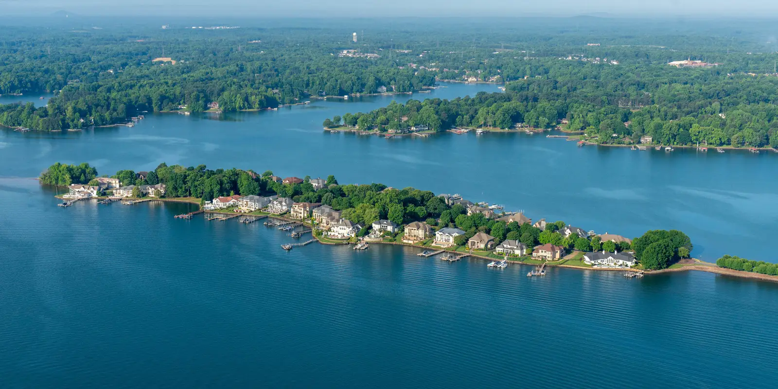 Aerial view of Governors Island and the waterfront homes and docks of Lake Norman on a summer morning