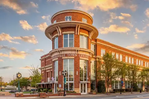 Huntersville Town Center building and historic town clock in downtown Huntersville, North Carolina at sunset