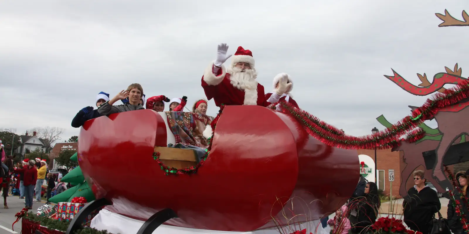 Holiday parade processional featuring marching units and Santa Claus traveling through town in North Carolina