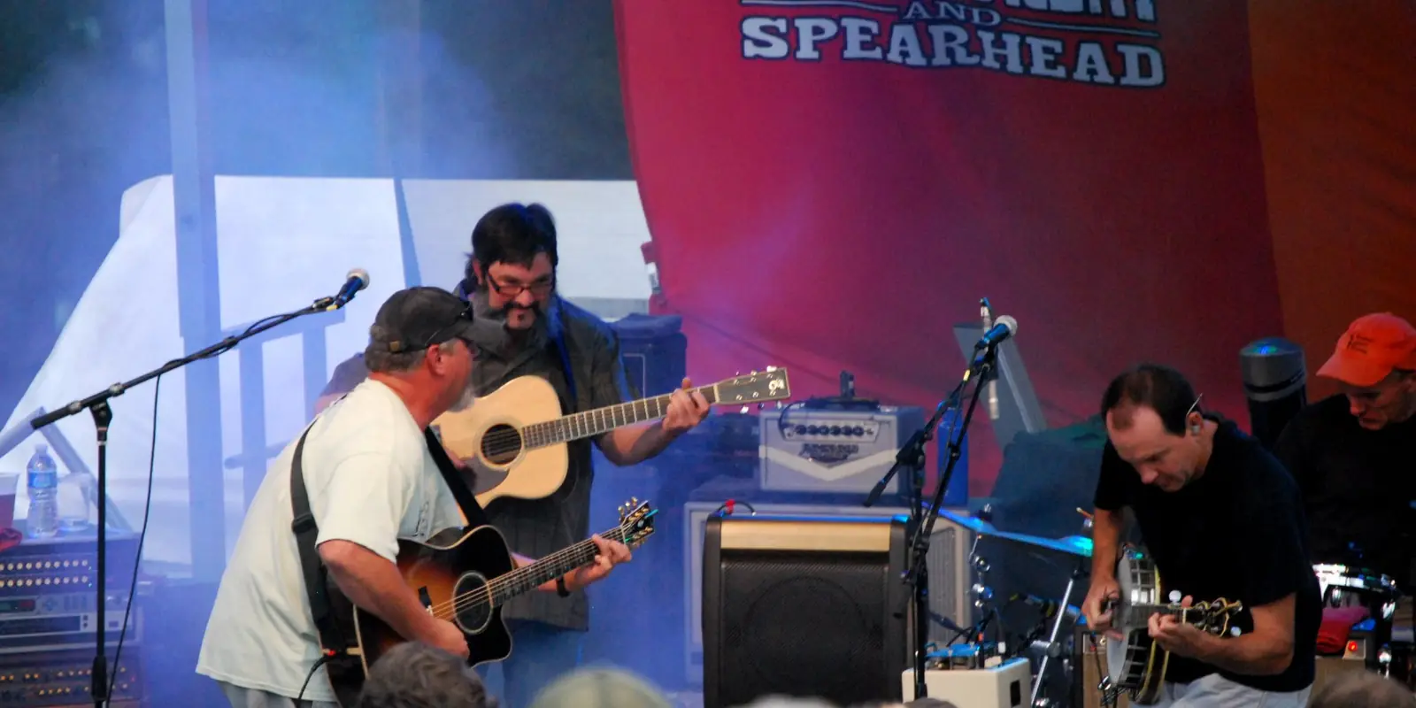 Live acoustic musical performance on an outdoor stage during an evening concert in North Carolina