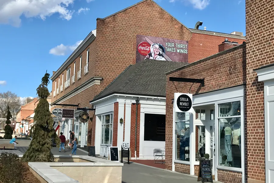 Pedestrian walkways, retail storefronts, and outdoor dining along West Avenue in downtown Kannapolis, North Carolina