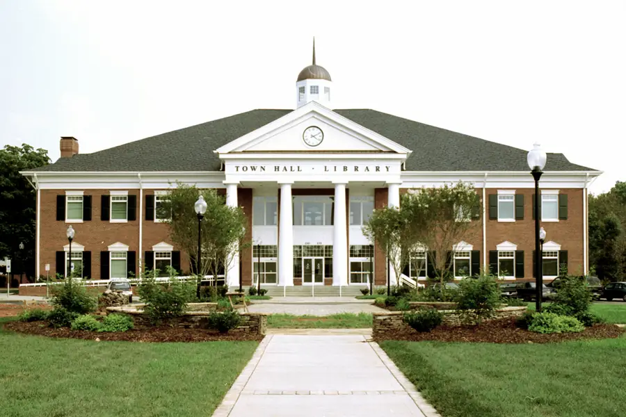 Red brick civic building and plaza at the Matthews Town Hall and Library Campus