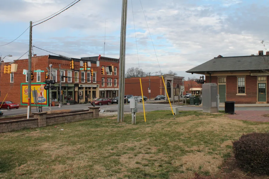 Historic brick commercial storefronts and sidewalks along Broad Street in downtown Mooresville, North Carolina