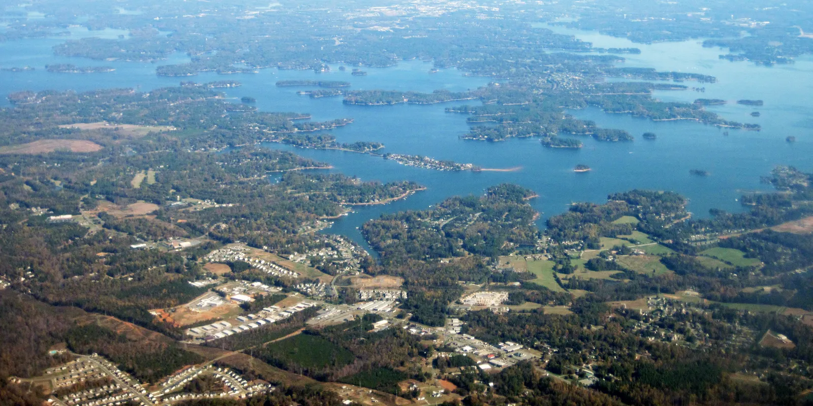 Calm water and forested shoreline on Lake Norman during summer recreation season