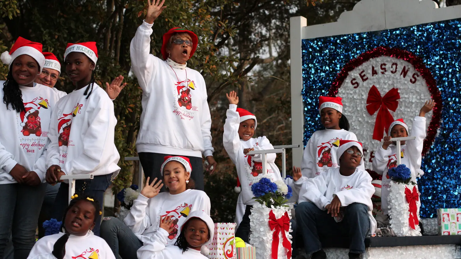 Community holiday parade procession along decorated commercial corridor