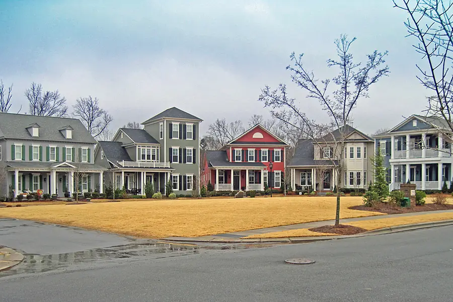 Traditional architecture and manicured streetscapes of Antiquity Village in Cornelius under a clear blue sky
