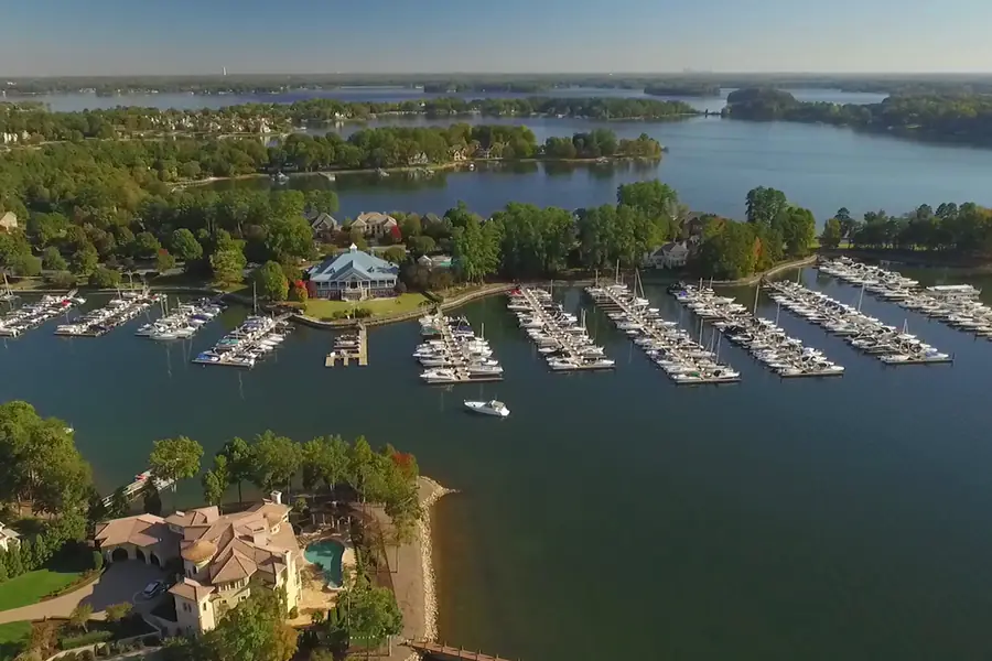 Aerial view of boat slips, marina docks, and waterfront amenities at the Peninsula Yacht Club in Cornelius on Lake Norman