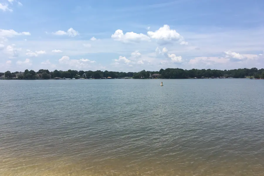 Calm blue waters and wooded peninsula shoreline at Ramsey Creek Park on Lake Norman in Cornelius