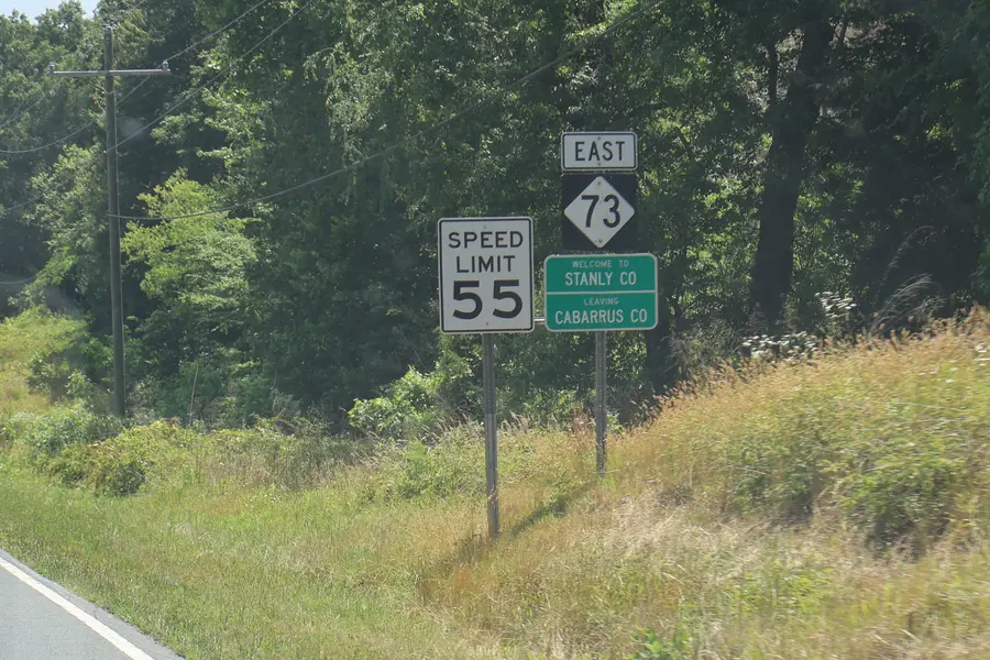 Highway sign welcoming motorists across the Cabarrus and Stanly County border along North Carolina Highway 73