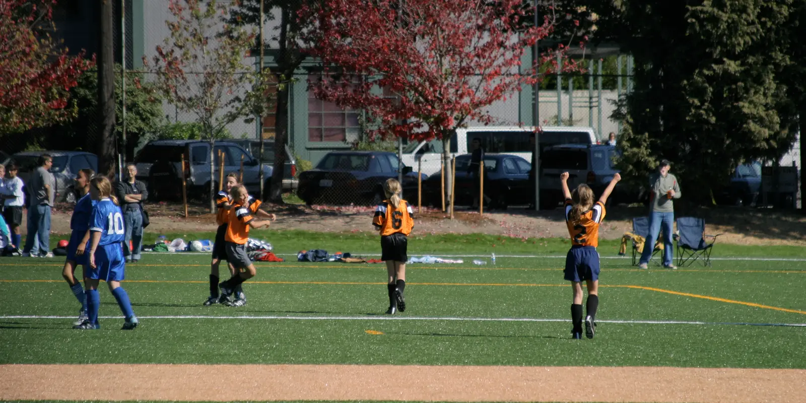 Youth soccer players competing with spirited teamwork on an outdoor community sports field