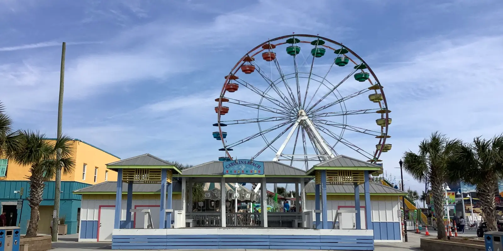 Colorful festival ferris wheel and carnival rides at an outdoor community celebration