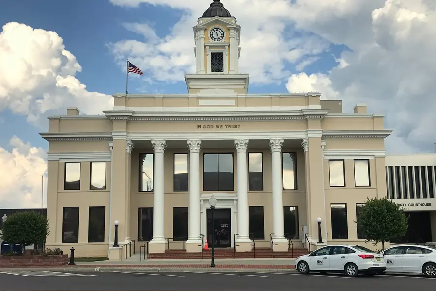 Classical Georgian Revival brick facade and monumental portico columns of the historic Davie County Courthouse in Mocksville