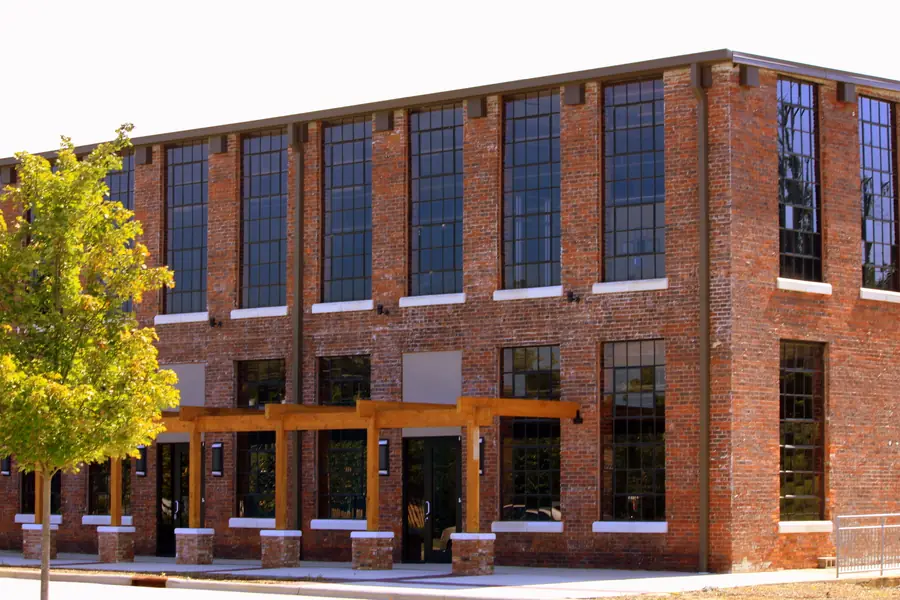 Historic 1875 Mount Holly Cotton Mill brick facade along the Catawba River in Mount Holly, North Carolina