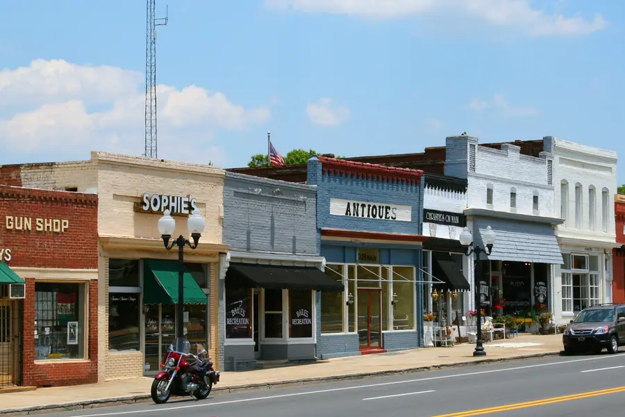 Historic brick storefronts and walkable streetscape along Main Street in downtown Pineville, North Carolina
