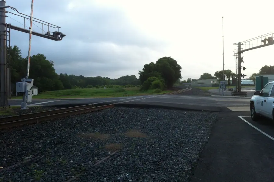 Railroad tracks and historic crossing signal commemorating rail heritage in Pineville, North Carolina