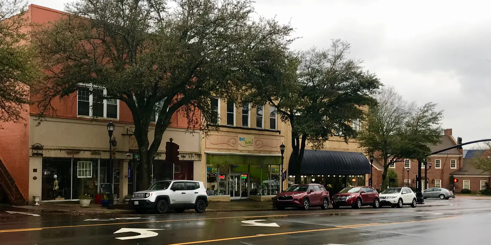 Restored brick storefronts and pedestrian retail avenues along Court Square during festival season in Uptown Shelby, North Carolina