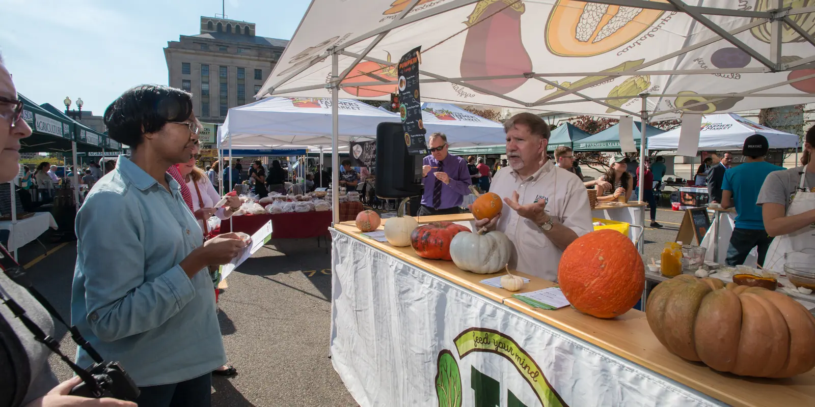 Fresh locally harvested farm produce and artisan goods displayed at an outdoor community market