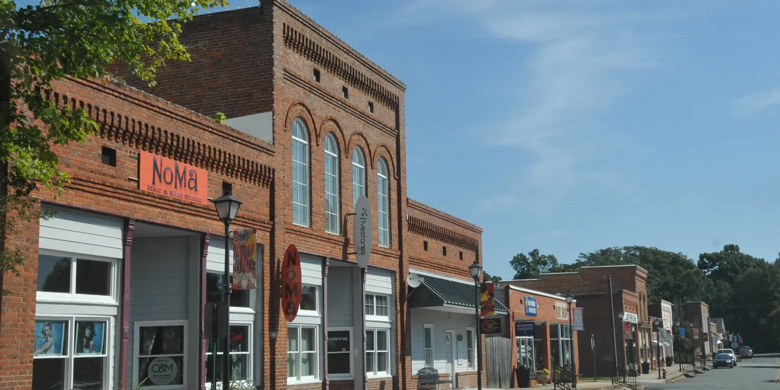 Historic district commercial streetscape with railroad median during autumn festival season in Waxhaw, North Carolina