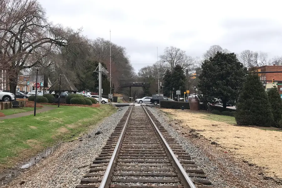 Historic Waxhaw overhead pedestrian footbridge spanning active railroad tracks in downtown Waxhaw, North Carolina